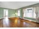 Spacious living room with hardwood floors, large window, and neutral green walls at 301 Colescott St, Shelbyville, IN 46176