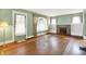 Bright living room with hardwood floors, fireplace, built-in shelves, and natural light at 301 Colescott St, Shelbyville, IN 46176