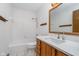 Clean bathroom features a tiled tub and wood vanity at 3136 River Bay N Dr, Indianapolis, IN 46240
