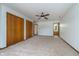 Spacious bedroom features neutral carpet, ceiling fan, and closet space at 3136 River Bay N Dr, Indianapolis, IN 46240