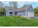 Charming single-Gathering home with a two-car garage and a well-manicured lawn and flowerbeds at 3136 River Bay N Dr, Indianapolis, IN 46240