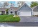 Charming single-Gathering home with a two-car garage and a well-manicured lawn and flowerbeds at 3136 River Bay N Dr, Indianapolis, IN 46240