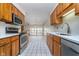 Bright, updated kitchen featuring stainless steel appliances and tiled backsplash, with a view to the living room at 3136 River Bay N Dr, Indianapolis, IN 46240