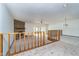 Large living room with stone fireplace and wood railing at 3136 River Bay N Dr, Indianapolis, IN 46240