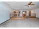 Spacious living room featuring neutral carpet, wooden railing and a ceiling fan at 3136 River Bay N Dr, Indianapolis, IN 46240