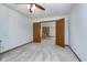Spacious room with neutral carpet, a ceiling fan and a stone fireplace in the background at 3136 River Bay N Dr, Indianapolis, IN 46240