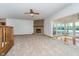 Bright living room featuring a stone fireplace, neutral carpet and lots of light at 3136 River Bay N Dr, Indianapolis, IN 46240