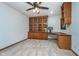 Home office with built in wooden shelving, desk, and neutral colored carpet at 3136 River Bay N Dr, Indianapolis, IN 46240