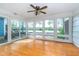Bright sunroom featuring hardwood floors and large windows with a scenic view of the lake at 3136 River Bay N Dr, Indianapolis, IN 46240