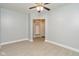 Clean bedroom featuring grey walls, white trim, new laminate flooring, and ceiling fan at 3180 Graceland Ave, Indianapolis, IN 46208