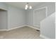 Bright dining room with gray walls, white trim, a modern light fixture, and new laminate flooring at 3180 Graceland Ave, Indianapolis, IN 46208