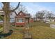Charming front exterior featuring red siding, a small porch, and a neatly maintained front yard at 3180 Graceland Ave, Indianapolis, IN 46208