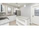 Bright kitchen with white cabinetry, granite countertops, stainless steel appliances, and laminate flooring at 3180 Graceland Ave, Indianapolis, IN 46208