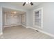 Bright living area showcasing neutral walls, laminate flooring, and large windows for natural light at 3180 Graceland Ave, Indianapolis, IN 46208