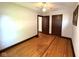 Bedroom with hardwood floors, neutral paint, and ample closet space at 324 E Southern Ave, Indianapolis, IN 46225