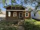 Charming brick home featuring a cozy front porch and neat landscaping at 324 E Southern Ave, Indianapolis, IN 46225