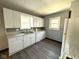 Kitchen featuring white cabinets and appliances with window for natural light at 324 E Southern Ave, Indianapolis, IN 46225