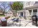 Backyard patio features outdoor seating, a brick accent wall, and a well-manicured lawn at 4134 N Pennsylvania St, Indianapolis, IN 46205