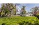 Large backyard with lush green lawn, mature trees, and an idyllic, private setting at 4134 N Pennsylvania St, Indianapolis, IN 46205