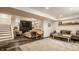 Finished basement features a cozy seating arrangement, a wooden table, and a large area rug at 4134 N Pennsylvania St, Indianapolis, IN 46205