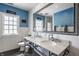 Charming bathroom featuring a vintage-style sink, and decor, with blue walls, a large window, and sleek fixtures at 4134 N Pennsylvania St, Indianapolis, IN 46205