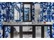 A stylish bathroom with a modern vanity and tub, showcasing bright blue and white wallpaper and elegant fixtures and mirrors at 4134 N Pennsylvania St, Indianapolis, IN 46205