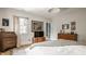 Bright bedroom featuring a desk, hard wood floors, artwork, and a window allowing natural light to illuminate the room at 4134 N Pennsylvania St, Indianapolis, IN 46205