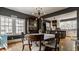 Bright dining room featuring hardwood floors, statement lighting and a view to the kitchen at 4134 N Pennsylvania St, Indianapolis, IN 46205