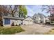 Spacious home with a detached garage and a large driveway, set amongst mature trees at 4134 N Pennsylvania St, Indianapolis, IN 46205
