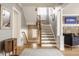 Stylish foyer with hardwood floors and staircase with natural light at 4134 N Pennsylvania St, Indianapolis, IN 46205