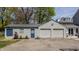 Detached two-car garage with a blue door, next to a well-maintained yard and landscaping at 4134 N Pennsylvania St, Indianapolis, IN 46205