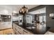 Modern kitchen featuring an island with a sink, gray cabinets, and stainless steel appliances at 4134 N Pennsylvania St, Indianapolis, IN 46205