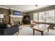Cozy living room with decorative fireplace, lots of seating, and bright windows at 4134 N Pennsylvania St, Indianapolis, IN 46205