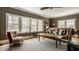 Comfortable living room featuring a ceiling fan, lots of bright windows and stylish furniture at 4134 N Pennsylvania St, Indianapolis, IN 46205