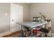 Home office nook featuring a modern desk, chair, shelving, and neutral wall paint, along with natural light from the window at 4134 N Pennsylvania St, Indianapolis, IN 46205