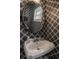 Stylish powder room features geometric wallpaper and a decorative oval mirror at 4134 N Pennsylvania St, Indianapolis, IN 46205