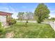 Well-maintained backyard with lush lawn, landscaping, and white picket fence at 4264 Amesbury Pl, Noblesville, IN 46062