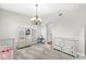 Bright bedroom with neutral walls, gray carpet, and decorative chandelier at 4264 Amesbury Pl, Noblesville, IN 46062