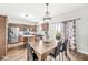 Dining area adjacent to kitchen, featuring wood floors and access to the backyard at 4264 Amesbury Pl, Noblesville, IN 46062