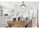 Open dining room with wood floors, chandelier, and views to other living spaces at 4264 Amesbury Pl, Noblesville, IN 46062