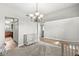 Bright entryway with carpet and wood floors, featuring a modern chandelier at 4264 Amesbury Pl, Noblesville, IN 46062