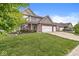 Two-story home with well-manicured lawn and three-car garage at 4264 Amesbury Pl, Noblesville, IN 46062