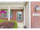 Inviting front porch with brick facade and well-maintained landscaping at 4264 Amesbury Pl, Noblesville, IN 46062