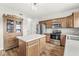 Well-lit kitchen with stainless steel appliances, wooden cabinets, and a center island at 4264 Amesbury Pl, Noblesville, IN 46062
