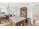 Kitchen island with a view of the adjacent dining and living areas at 4264 Amesbury Pl, Noblesville, IN 46062