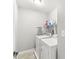 Functional laundry room with a washer, dryer, and storage shelf at 4264 Amesbury Pl, Noblesville, IN 46062