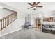 The living room is open to the kitchen and features a staircase and comfortable seating at 4264 Amesbury Pl, Noblesville, IN 46062