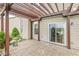 A charming outdoor patio area featuring a brick surface and a stylish wooden pergola, perfect for relaxation at 4264 Amesbury Pl, Noblesville, IN 46062