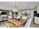 Dining room and kitchen area featuring stylish modern pendant lighting, stainless appliances and ample counter space at 4530 Laughter Ln, Indianapolis, IN 46235