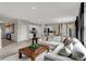 Spacious living room with hardwood floors, white trim, a comfortable sectional sofa, and an open layout at 4530 Laughter Ln, Indianapolis, IN 46235